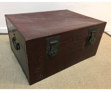 A Chinese red leather covered and brass embellished trunk, bearing painted Chinese script and "F.J. Abbott" to the front pane
