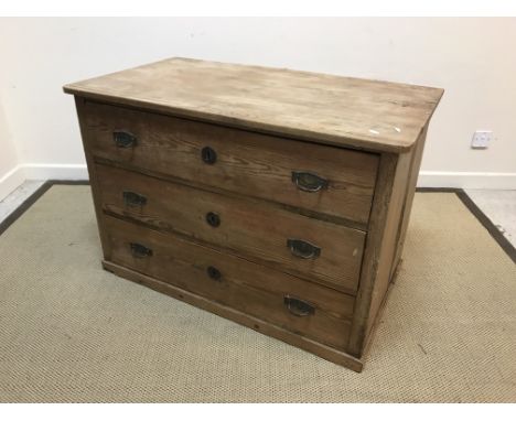 A 19th Century Continental pine commode, the plain top above three long drawers on a simple plinth base (feet missing), 106.5