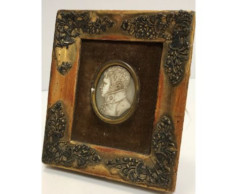 A 19th Century carved ivory portrait medallion on a gentleman in a high collared coat, housed in a gilt frame, the medallion 