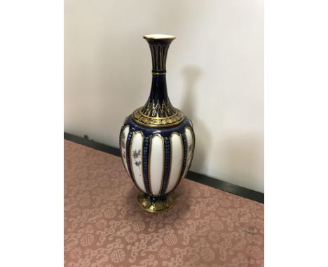 A Royal Worcester blue and gilt decorated stem vase with floral decoration bears blue mark to base and No'd 1799 20 cm high