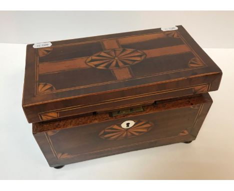 An early 19th Century mahogany and inlaid tea caddy with fan marquetry medallion decoration, raised on squat bun feet, 23 cm 