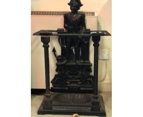 A Victorian cast iron stick stand as Admiral Lord Nelson stood beside an anchor raised on two hippocamps inscribed "Nelson", 