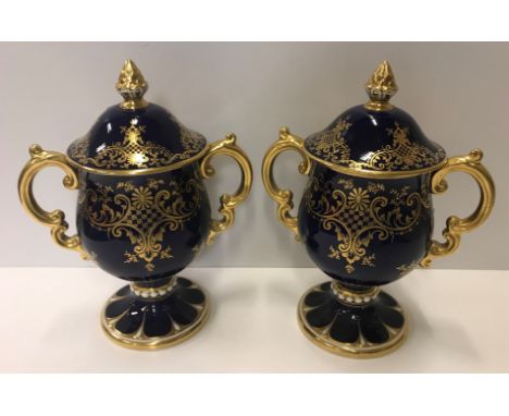 A pair of Coalport bleu royale and gilt decorated twin handled goblets and covers, No'd to base "V7944T", 22.5 cm high each C