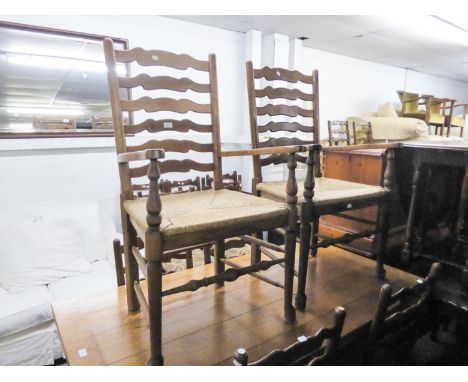A SET OF SIX OAK LADDER BACK DINING CHAIRS WITH RUSH SEATS (4 +2) 