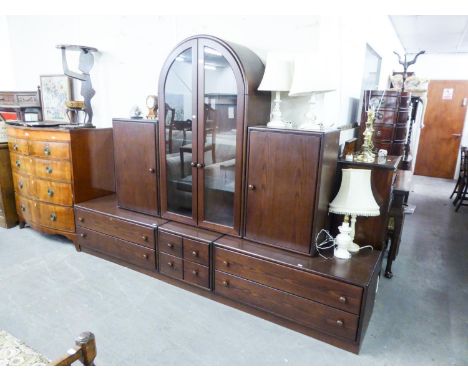 A GOOD QUALITY 'HULSTA' DARK OAK LOUNGE UNIT, THE UPPER SECTION HAVING CENTRAL ARCH GLAZED DOORS, FLANKED BY TWO SOLID DOORS,