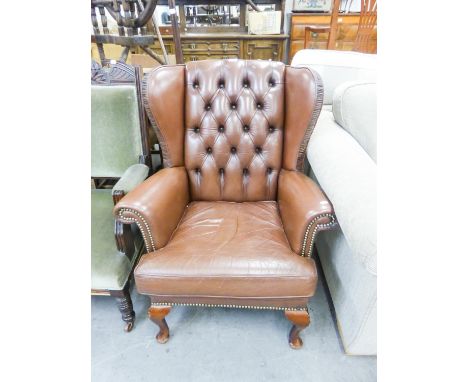 A REPRODUCTION FIRESIDE ARMCHAIR, WITH BROWN HIDE UPHOLSTERY AND BUTTON BACK, A REPRODUCTION MAHOGANY STANDARD LAMP (2) 