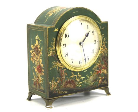 A 20th century Chinoiserie mantel clock. The textured dial with Arabic numerals, the wooden case painted green with a landsca
