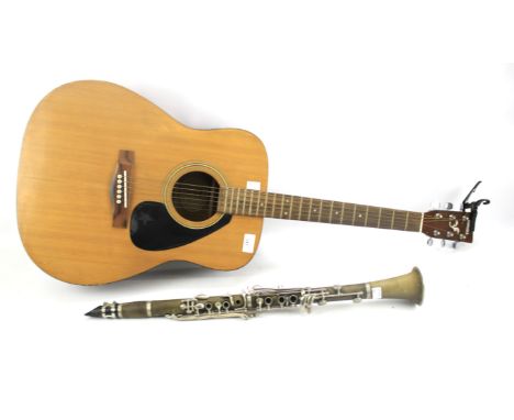 A Yamaha F-310 acoustic guitar and a clarinet. The guitar measuring 103cm long Condition Report: Clarinet is marked 'Viva! by