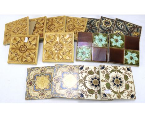 A collection of ceramic tiles. Of assorted colours and designs, some with floral decoration