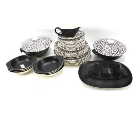 A Poole pottery part dinner service. Comprising dinner plates, side plates, two lidded tureens, sauce boat and saucer, etc
