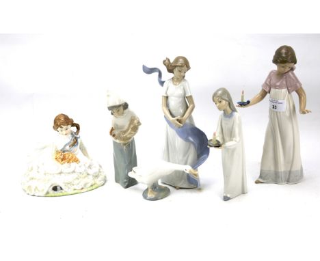 An assortment of ceramic figures. Comprising Royal Doulton 'Safe at Last', two Lladro and two Nao figures of girls and a Llad