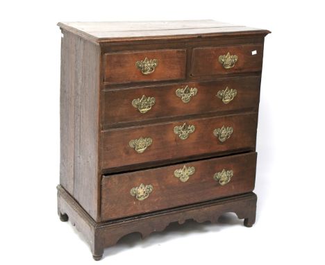 A 19th century oak chest of drawers. Two short over three long drawers, with metal handles, raised on bracket supports, L92cm