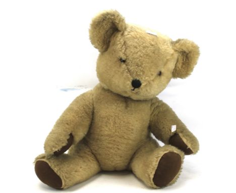 A Chad Variety teddy bear. Golden colour with glass eyes, a stitched nose and brown felt paws, H70cm