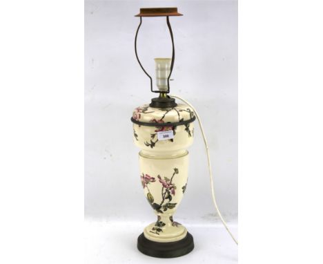 A late 19th century Bria &amp; Sons ceramic adapted table lamp. Decorated with flowers on thorn branches, raised on metal cir