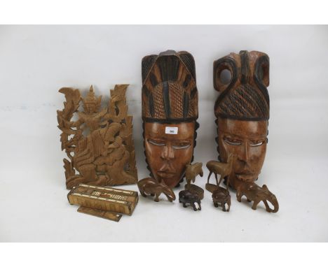 A collection of wooden items. Including carved face masks, a bone inlaid strapwork cribbage box containing dominoes, carved f