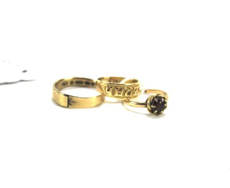 Three 9ct gold rings. Comprising an example with ruby in ropetwist setting, size N, an example inscribed MIZPAH, size L and a
