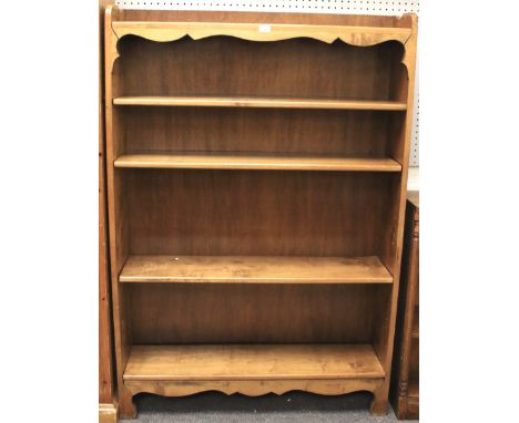 A 20th century stained pine bookshelf. With four adjustable shelved, raised on ogee bracket feet, L108cm x D24cm x H161cm