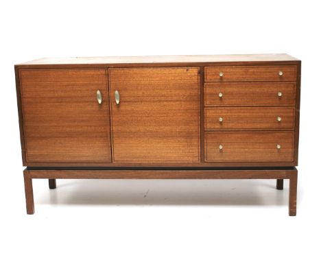 A 1970s teak sideboard. Featuring a pair of doors opening to reveal a single shelf, to the right a set of four graduated draw