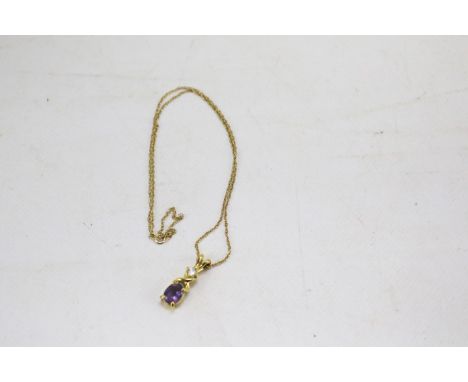 A 9ct gold necklace and yellow metal amethyst pendant. The rabbit shaped pendant set with an amethyst and a white stone. Gros