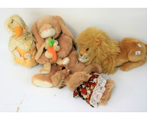 A group of four vintage soft toys. To include a large Steiff lion, number 064173, 'Bearly sane one of a kind' mohair hare, et