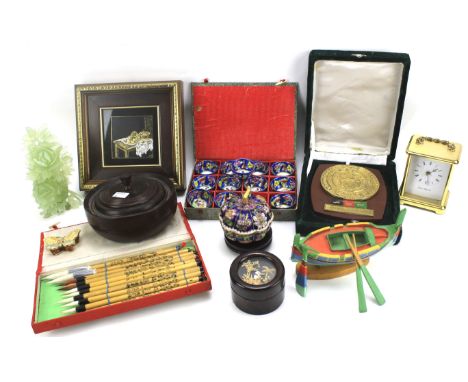 An assortment of collectables. Including a turned wood lidded pot, a wooden model of a boat, London Clock Co carriage clock a