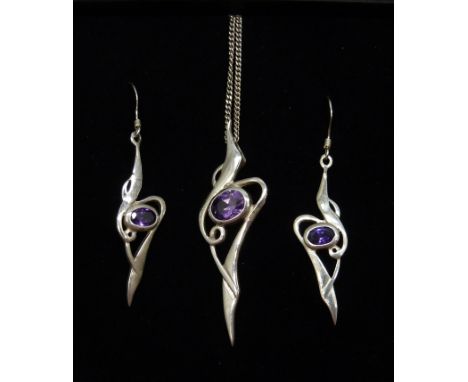 A silver and amethyst pendant and matching earrings 