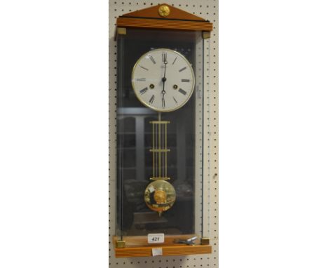 A contemporary German wall clock, by Hermle & Son, Roman numerals, twin winding holes, key and pendulum, glass case 59cm