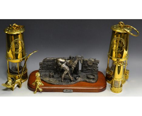 A brass Eccles Miners lamp; a novelty lamp as a Miners lamp; a miniature Miners lamp; a last figure group- The Hostler