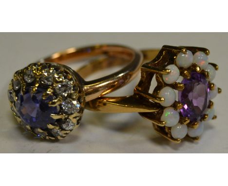 A rose gold coloured metal cluster ring, central blue and purple stone surrounded by eleven diamonds; a 9ct gold amethyst and