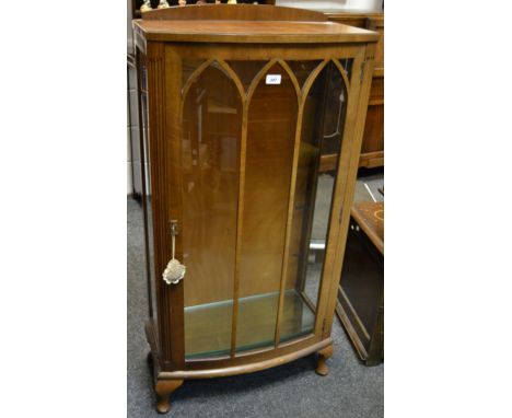  A 1940's bowfront display cabinet, astragal glazed door enclosing shelving. 125cm high x 61cm wide x 32cm deep.