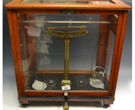 A set of chemistry scales in a mahogany and glass case manufactured by L. Oertling Ltd. London. E. C.
