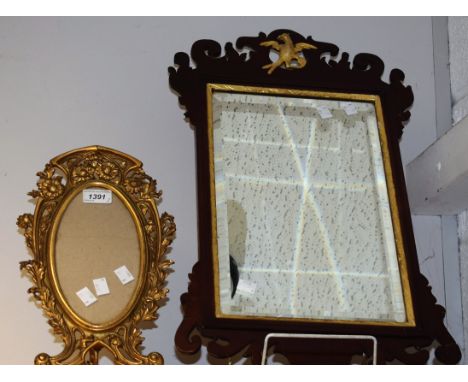 An Art Nouveau shaped oval gilt metal photograph frame, cast with flowers and scrolling foliage, easel back, 34cm high; a Geo