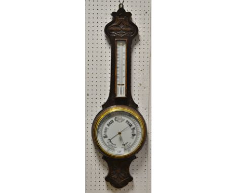 An early 20th Century carved oak banjo barometer