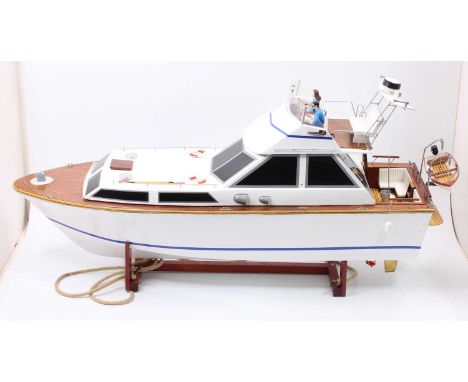 A GRP hulled and wooden kit built model of a Princess 37 Flybridge cruiser, comprising of white and blue lined body with stai