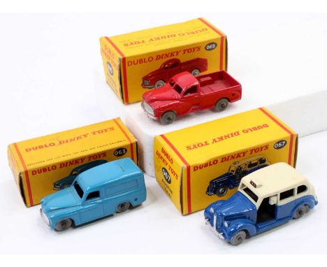 A collection of three boxed 00 Dinky Toys to include a No. 065 Morris pickup, No. 067 Austin Taxi, and No. 063 Commer van, al