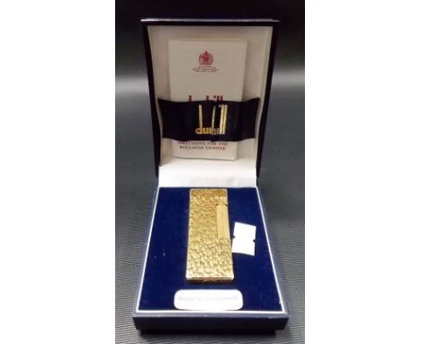 Dunhill gold plated Rollagas lighter with textured decoration within original fitted case with instructions.