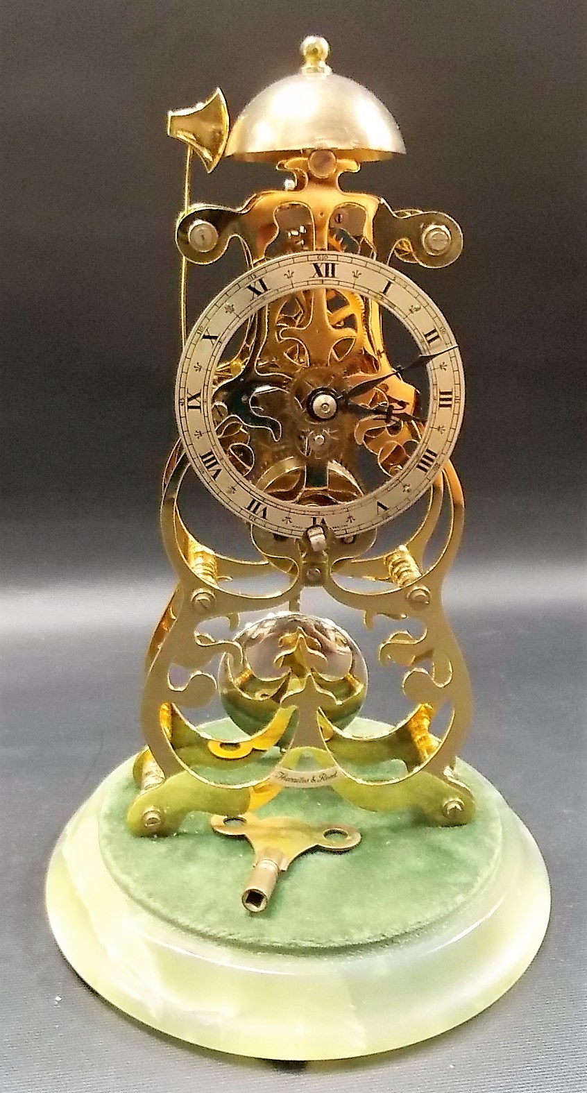 A Thwaites & Reed brass skeleton clock, the silvered chaptering with