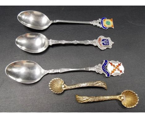 Three silver and enamel souvenir teaspoons 'St. Austell', 'St. Ives' and ' Falmouth'; together with a pair of silver gilt 925