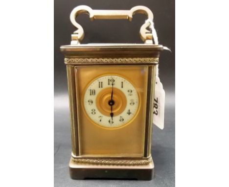 Brass carriage timepiece with 1.75" cream dial with Arabic Numerals & with a gilt textured surround, height inc. handle 6"