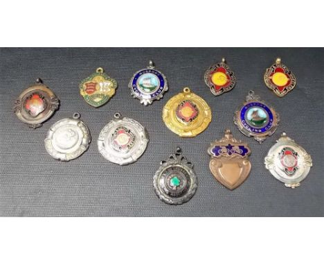 Collection of twelve various enamel & metal cycling club fobs, 1920's-50's