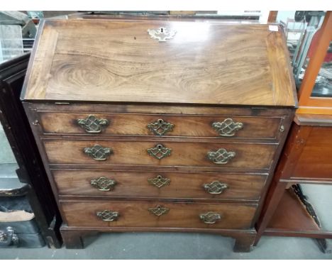 George III mahogany bureau, the fall front enclosing an arrangement of six drawers, a cupboard and four pigeonholes and with 