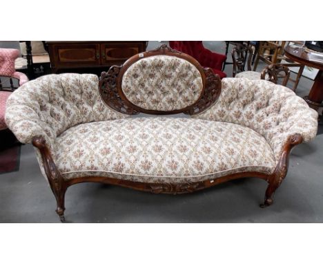 Good Victorian walnut framed button backed upholstered salon settee, the central oval back with foliate scroll carved and pie