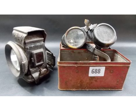 A pair of vintage motorcycle goggles; together with spare glass lenses & a vintage tin plate bicycle lamp