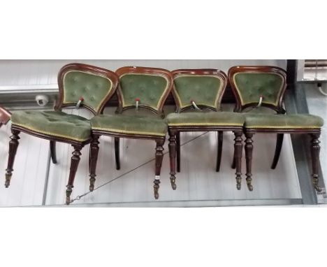 Set of four Victorian mahogany spoon back button upholstered dining chairs with carved and turned forelegs with brass caps an