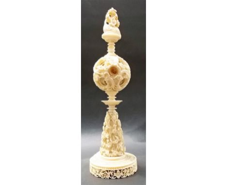 Good 19th Century Chinese ivory concentric puzzle ball, profusely carved, with a toad finial over the 2.5" diameter concentri