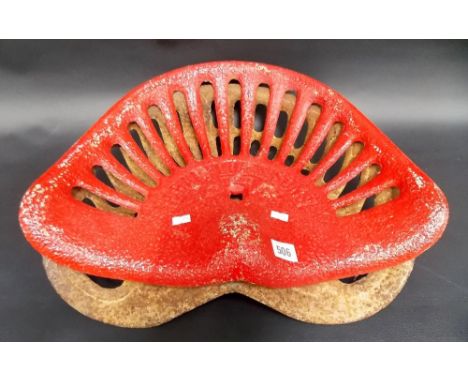 Two cast iron tractor seats.