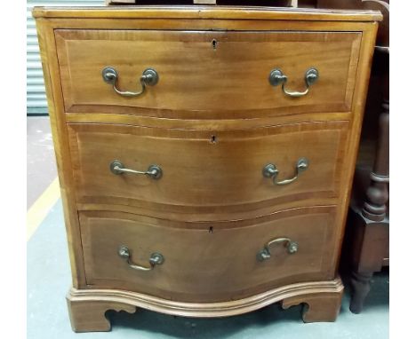 George III style mahogany cross banded serpentine front chest of three long drawers upon bracket feet, width 29"