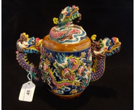 A large Taiwan-Cochin ceramic teapot, elaborately decorated in the majolica-style with dragons, impressed seal marks to base,