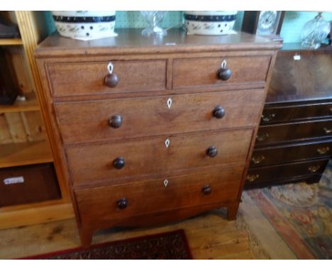 A 20th century oak chest, having two short over three long graduated drawers on bracket feet, 98cm wide.
