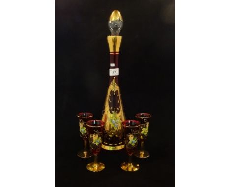 An early 20th century Venetian glass ruby red decanter, having gilt and floral decoration, together with four conforming glas